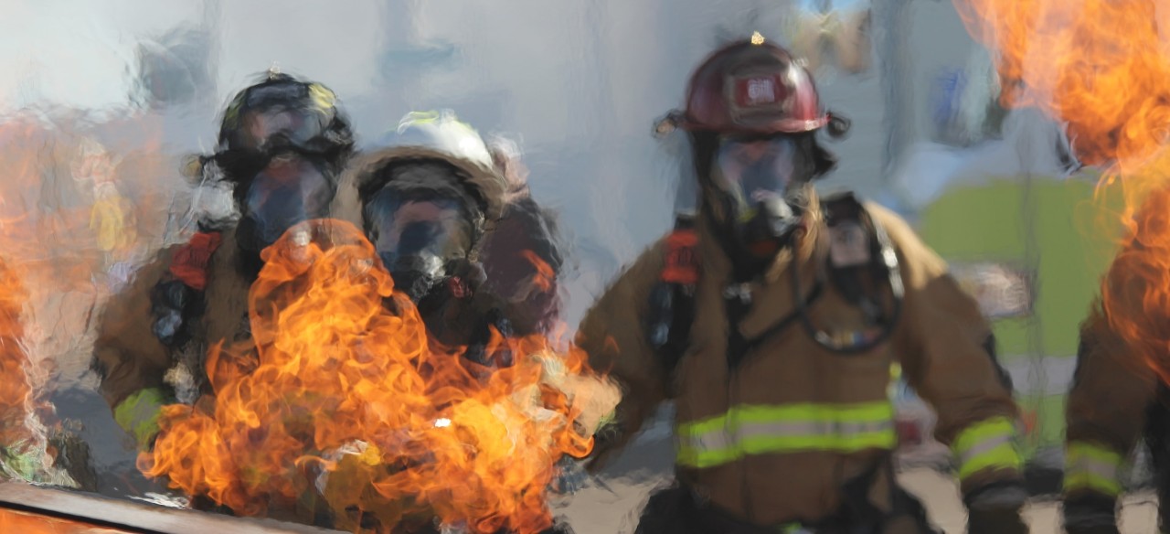 three fireman going into a fire