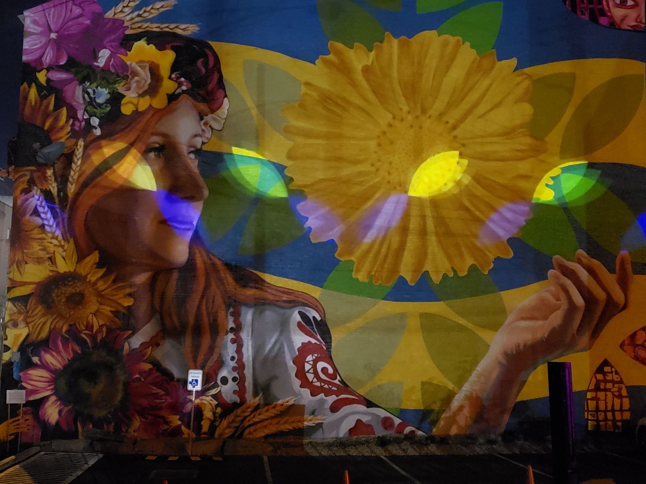 mural of Ukrainian woman with large sunflower