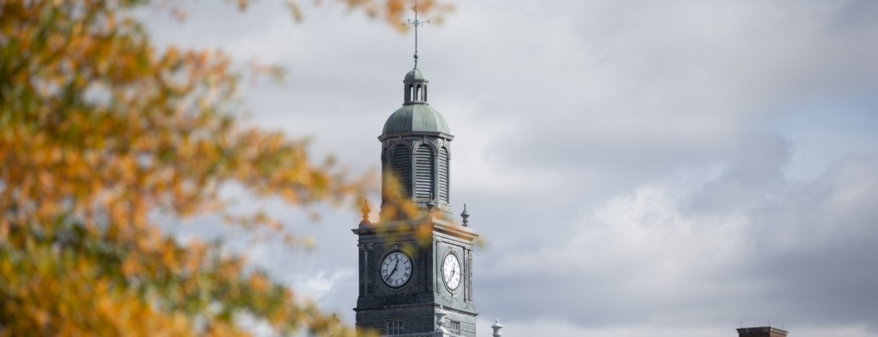 Fall leaves surround a clocktower 