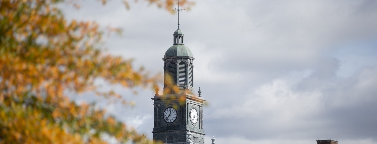 Fall leaves surround a clocktower