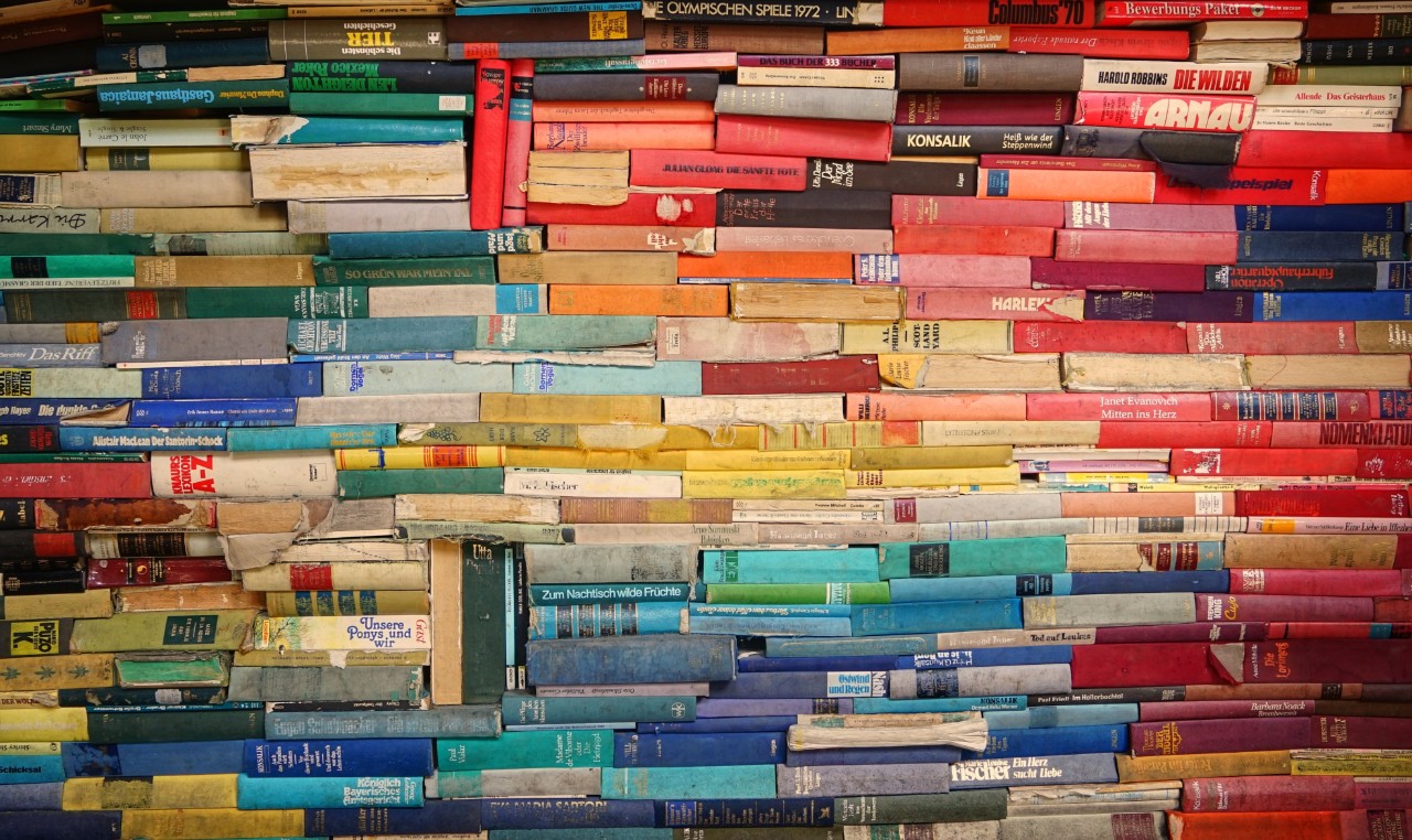 Stacks of books in a variety of colors.
