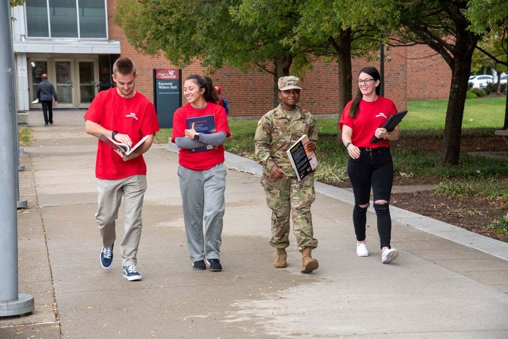 four student Veterans walking outside at UC Blue Ash