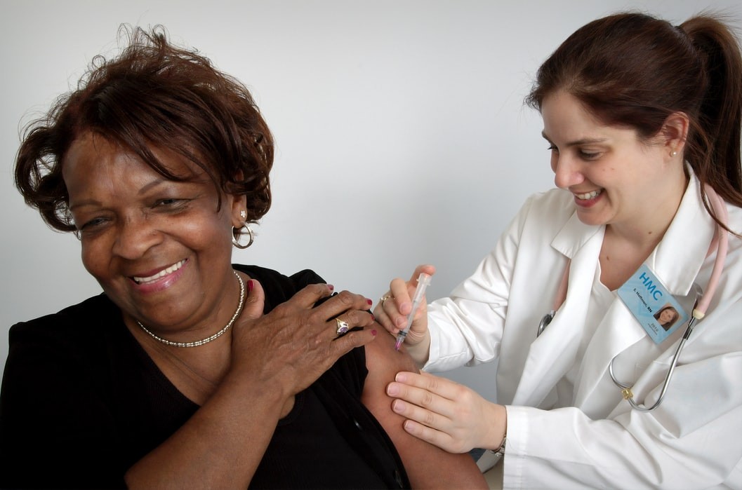 A woman receives a flu shot