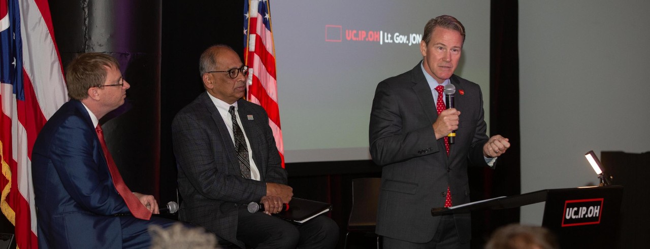 Ohio Lt. Gov. Jon Husted speaks during an Ohio IP Promise event at UC’s 1819 Innovation Hub as UC Executive Vice President Ryan Hays and UC President Neville Pinto look on.
