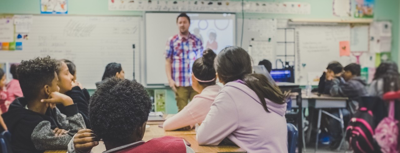 teacher at front of room with children