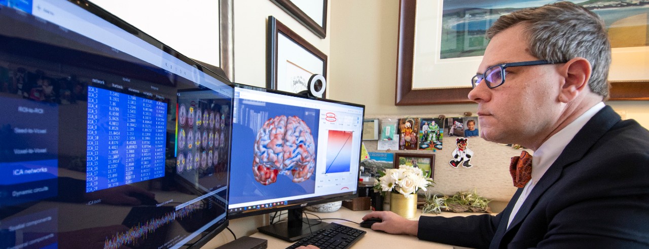 Dr. Strawn looks at data on two computer screens