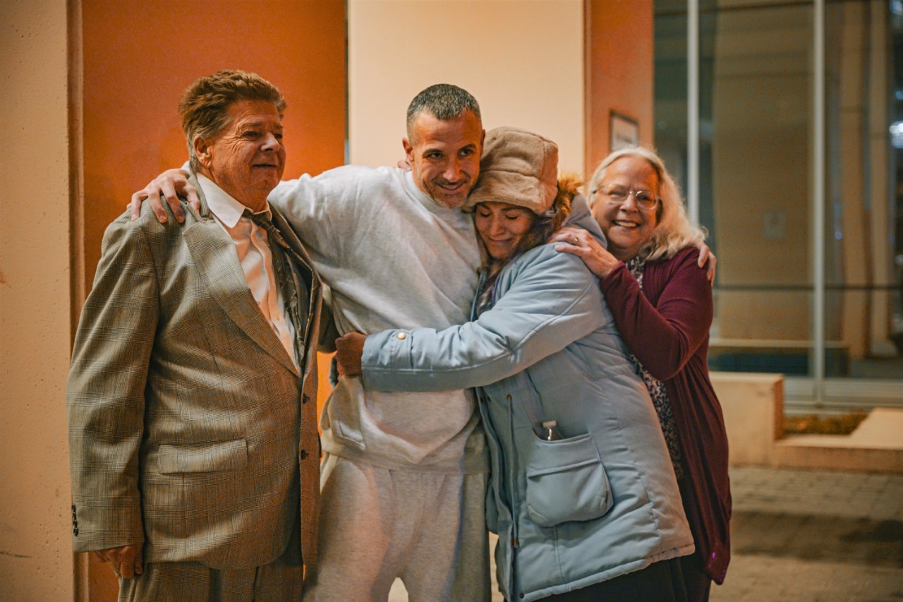 Alan Butts, in grey sweats, with his family at a long-awaited reunion.