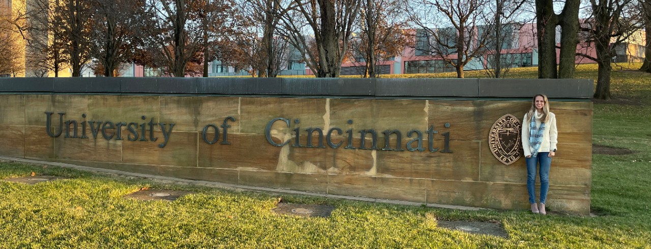 Julia Rabin standing in front of UC entrance gate 