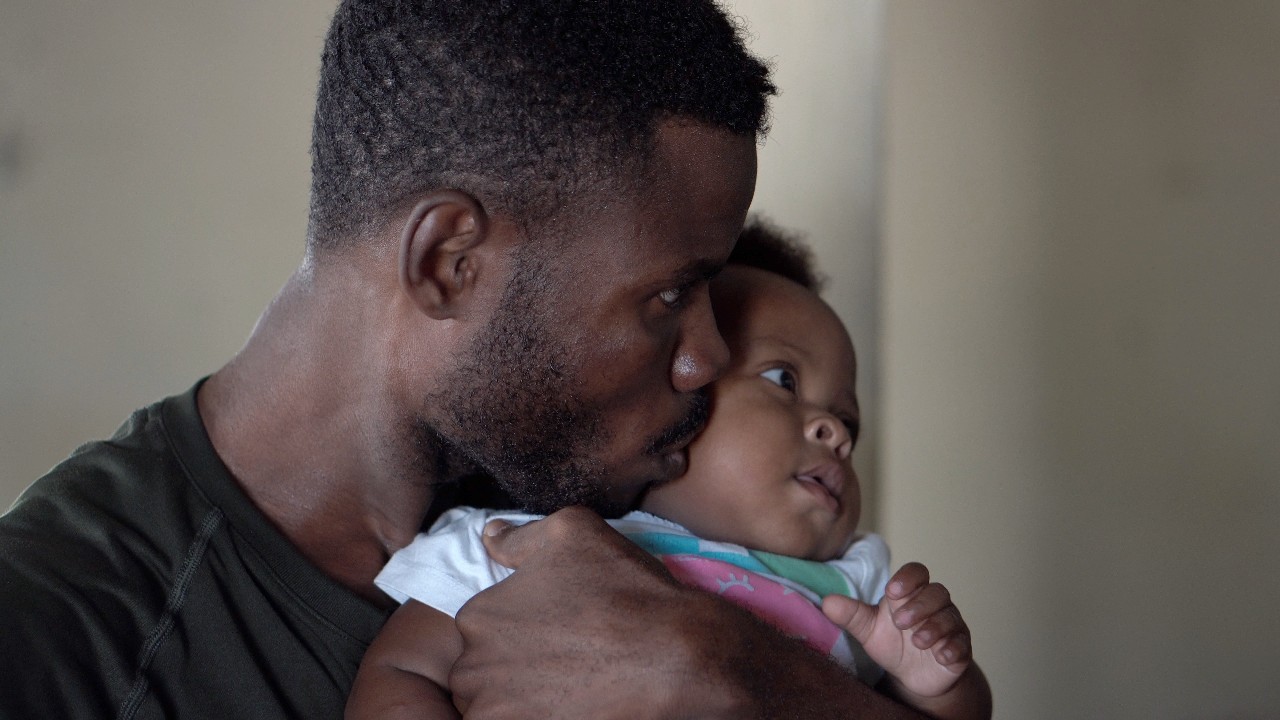 A father kisses a baby