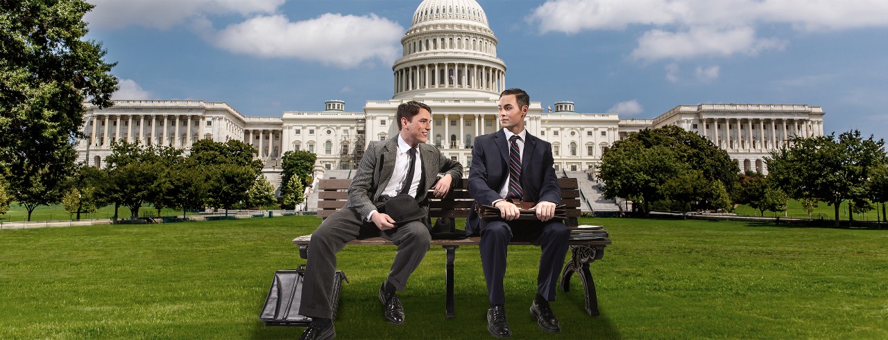 Two men sit on a bench and converse in front of the United States Capitol Building in a promotional image for CCM's production of the opera 'Fellow Travelers.' Photo/Mark Lyons
