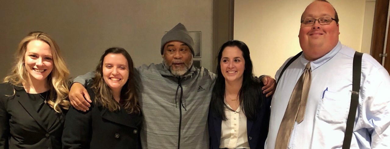 Charles Jackson, center, with members of the OIP team who worked to secure his release. From left, Liza Dietrich, Maddy High, Mallorie Thomas and Donald Casto. Photo provided.