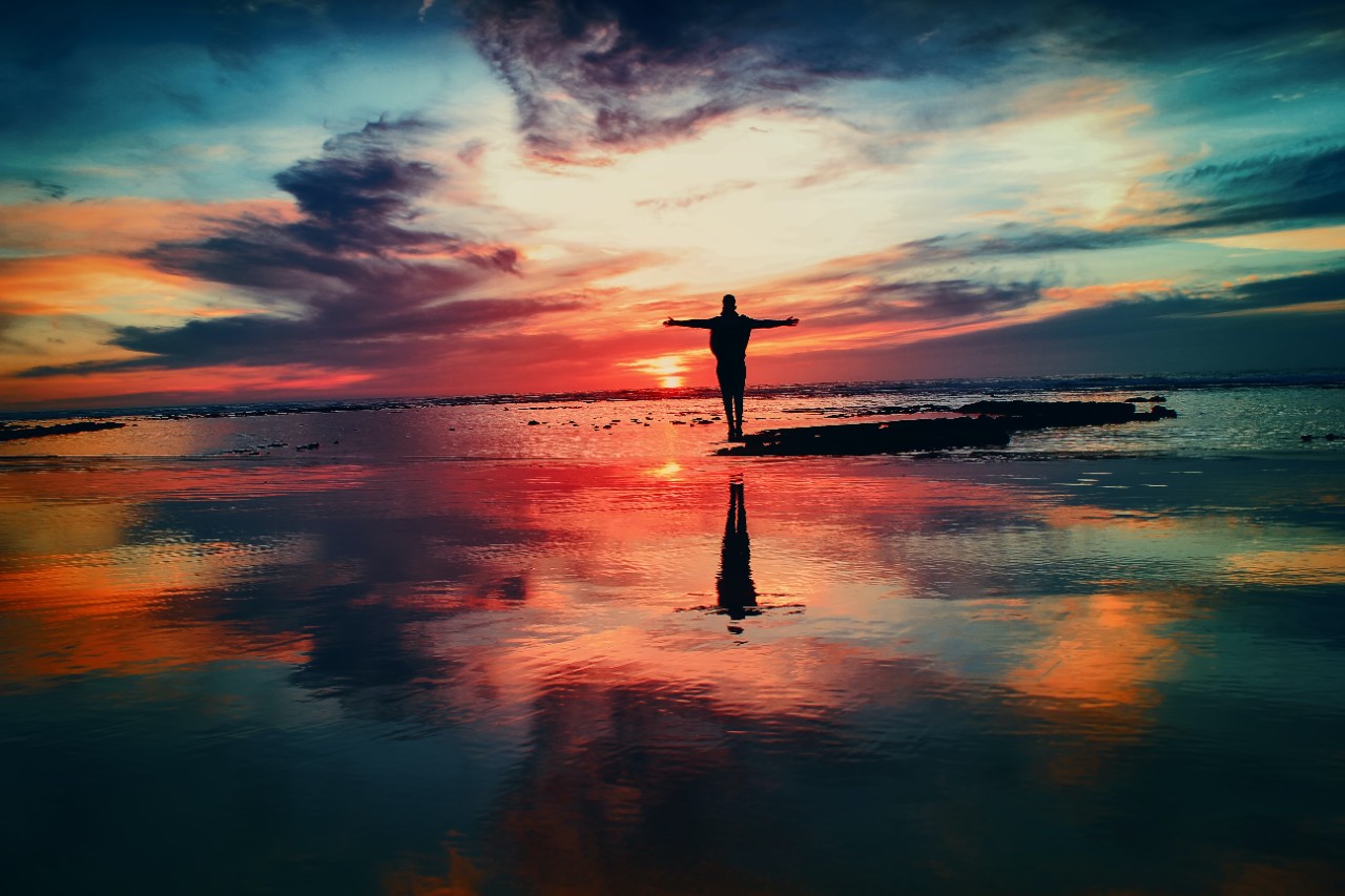 Image of a person outdoors enjoying freedom. From Unsplash.