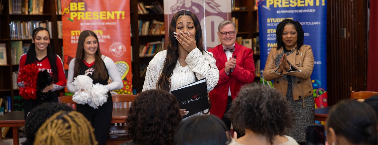 Helen Dawit looks shocked as UC crew surprises her at school