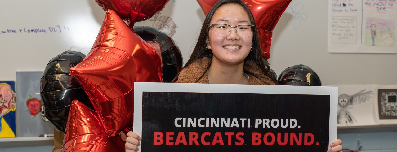 student holding Bearcats Bound UC sign