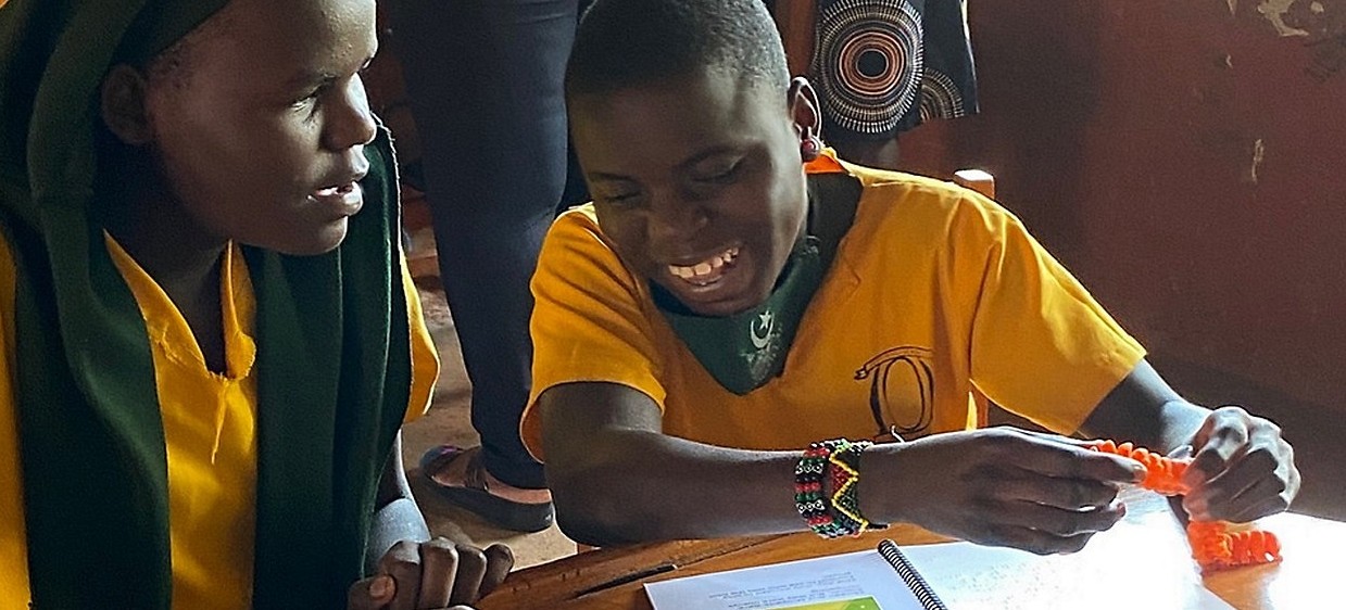 Uganda school children with braille books 