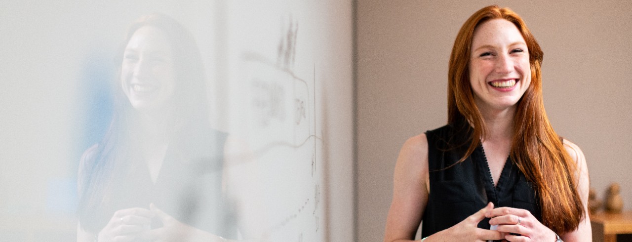 A woman in front of a whiteboard