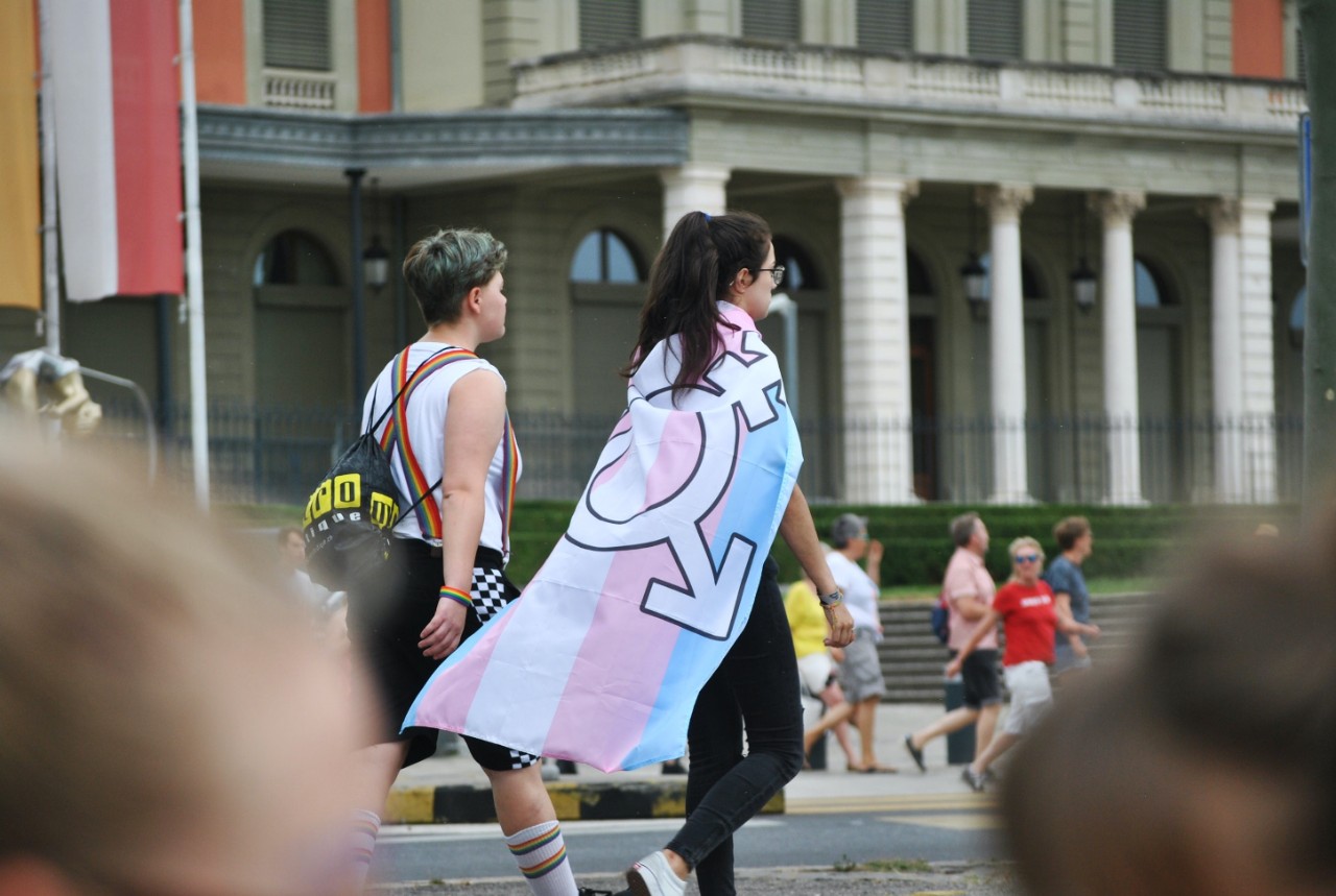 Image of people marching in a PRIDE event