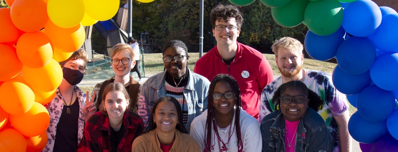 University of Cincinnati and Lindner College of Business students post for a picture at an event.