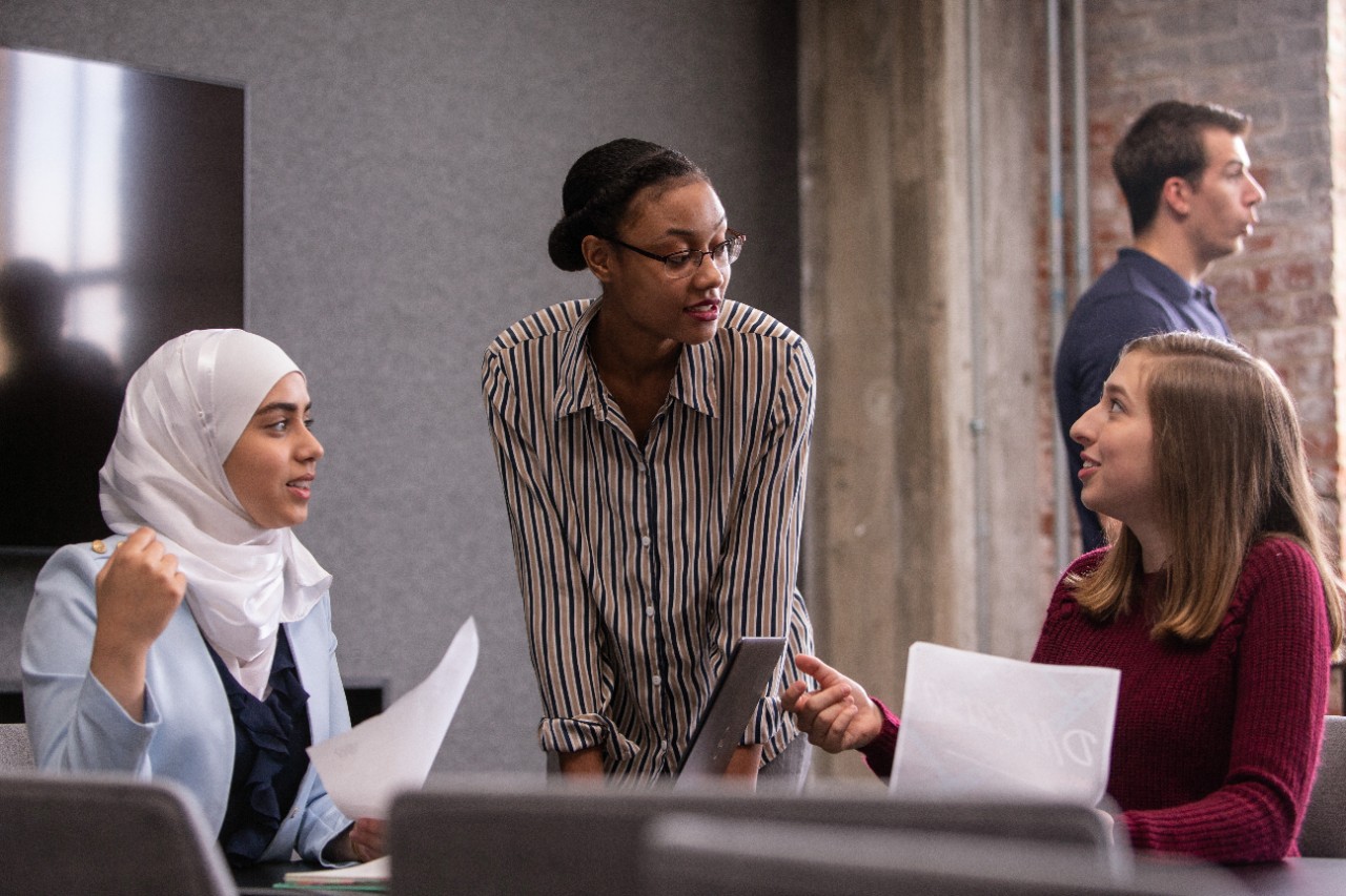 Students conversing in a conference room