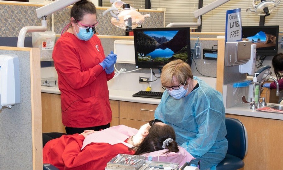 Dental Hygiene faculty and staff work on a patient in the UC Blue Ash dental clinic