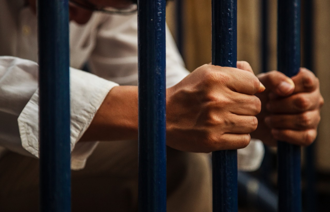 inmate behind bars image