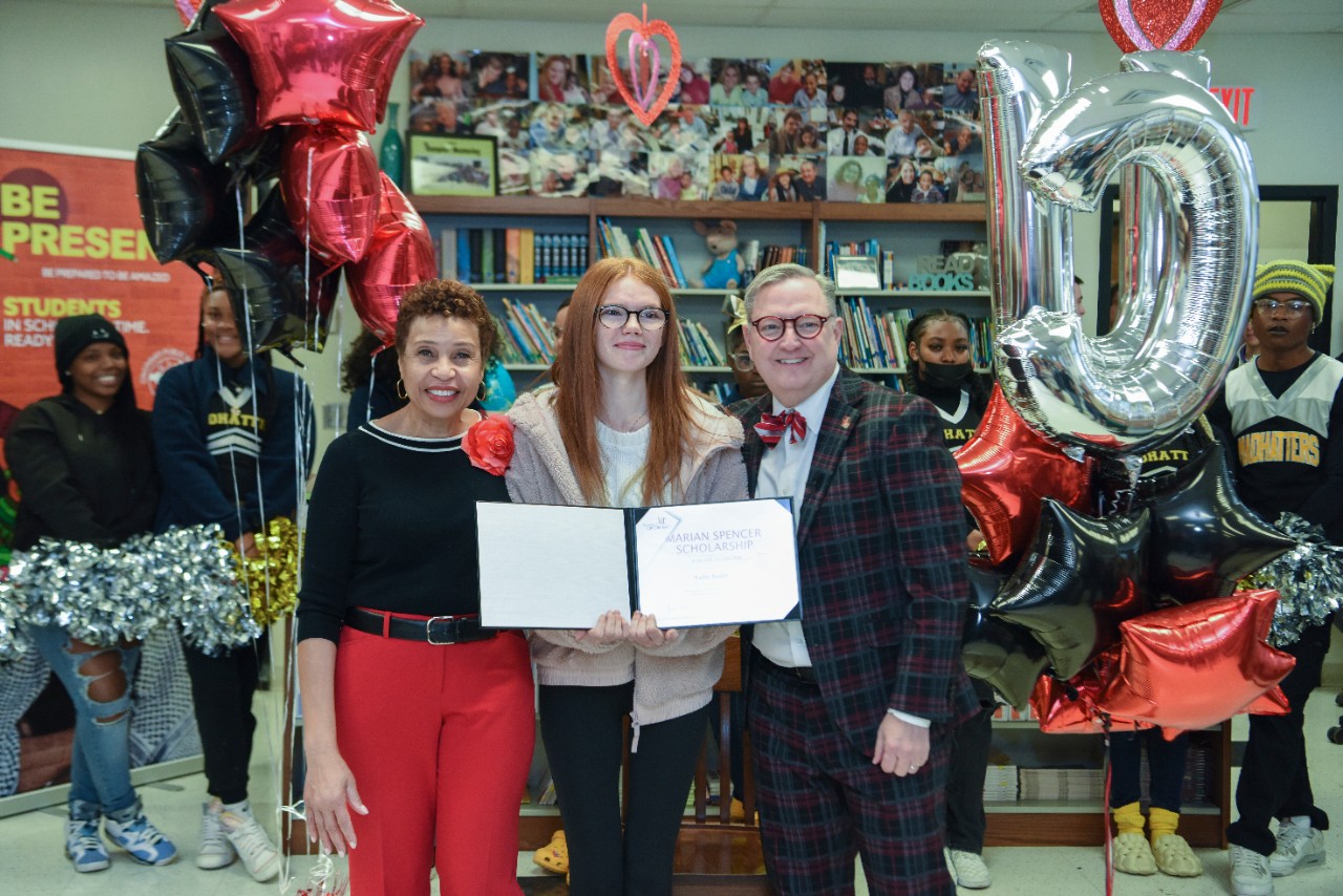 Sadie Smith, center, is congratulated by UC's Cindy Jones and Jack Miner