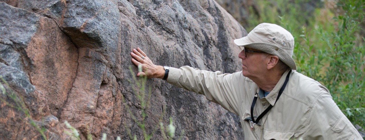 University of Cincinnati Department of Geosciences head Craig Dietsch studies a cliff face in Canada.