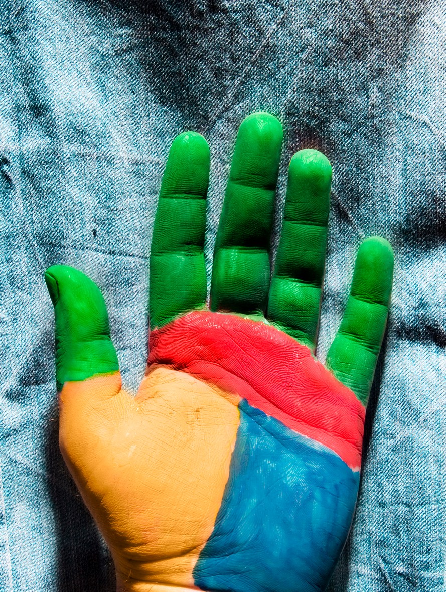 Photo of painted hand on denim background
