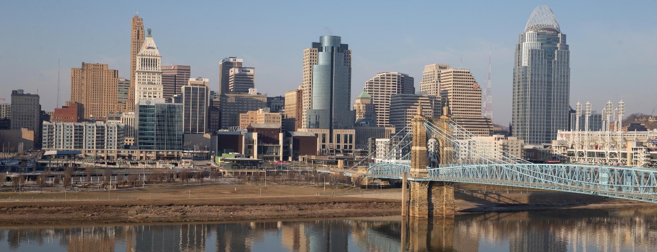 The Cincinnati skyline is reflected in the Ohio River.