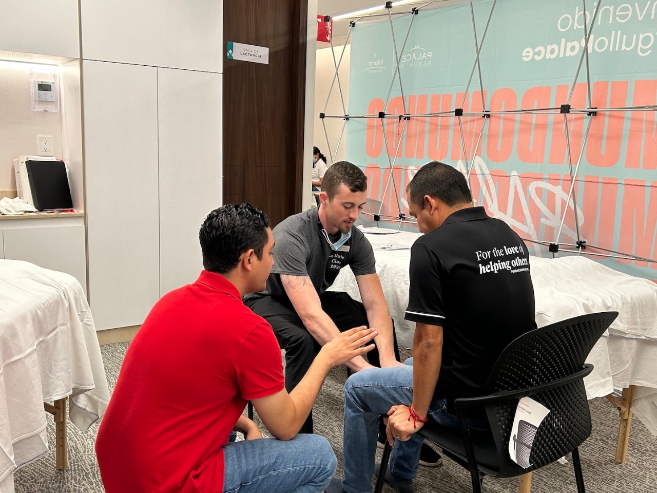 UC Clermont physical therapist assistant student Jesse Anderson demonstrates a home exercise program to a client with help from an interpreter in Mexico. 