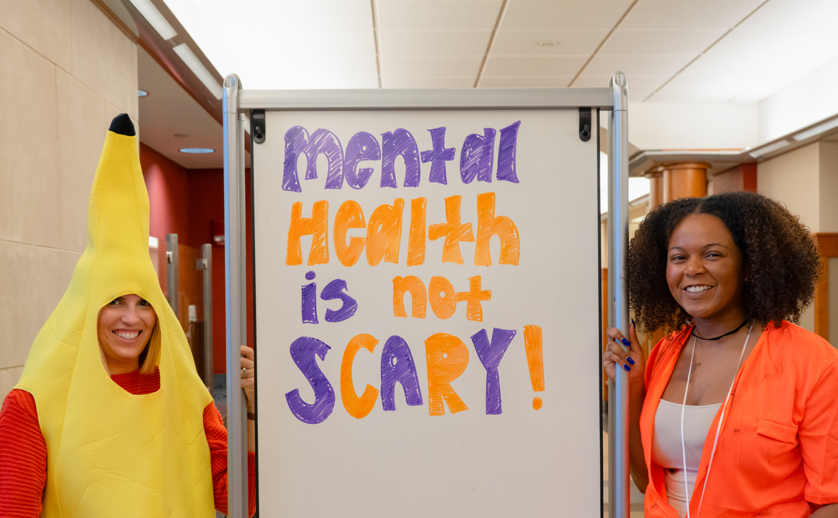 Muller (left) helps with hosting a Halloween-themed mental health workshop in Teachers-Dyer Complex. 