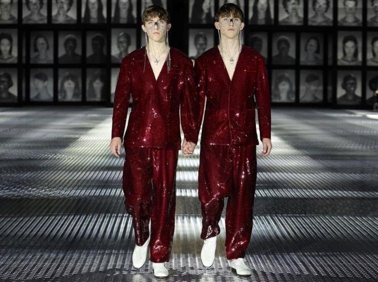 Identical twins Jake and Nate Bartel walk the runway in red sequin suits at the Gucci 2022 runway show in Milan, Italy. 