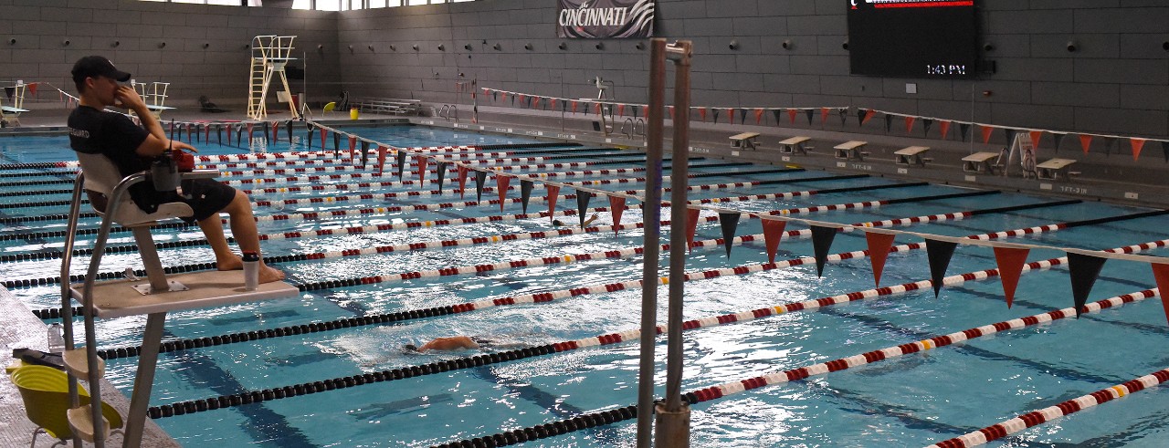 Lifeguard in tall chair oversees activity in lap pool