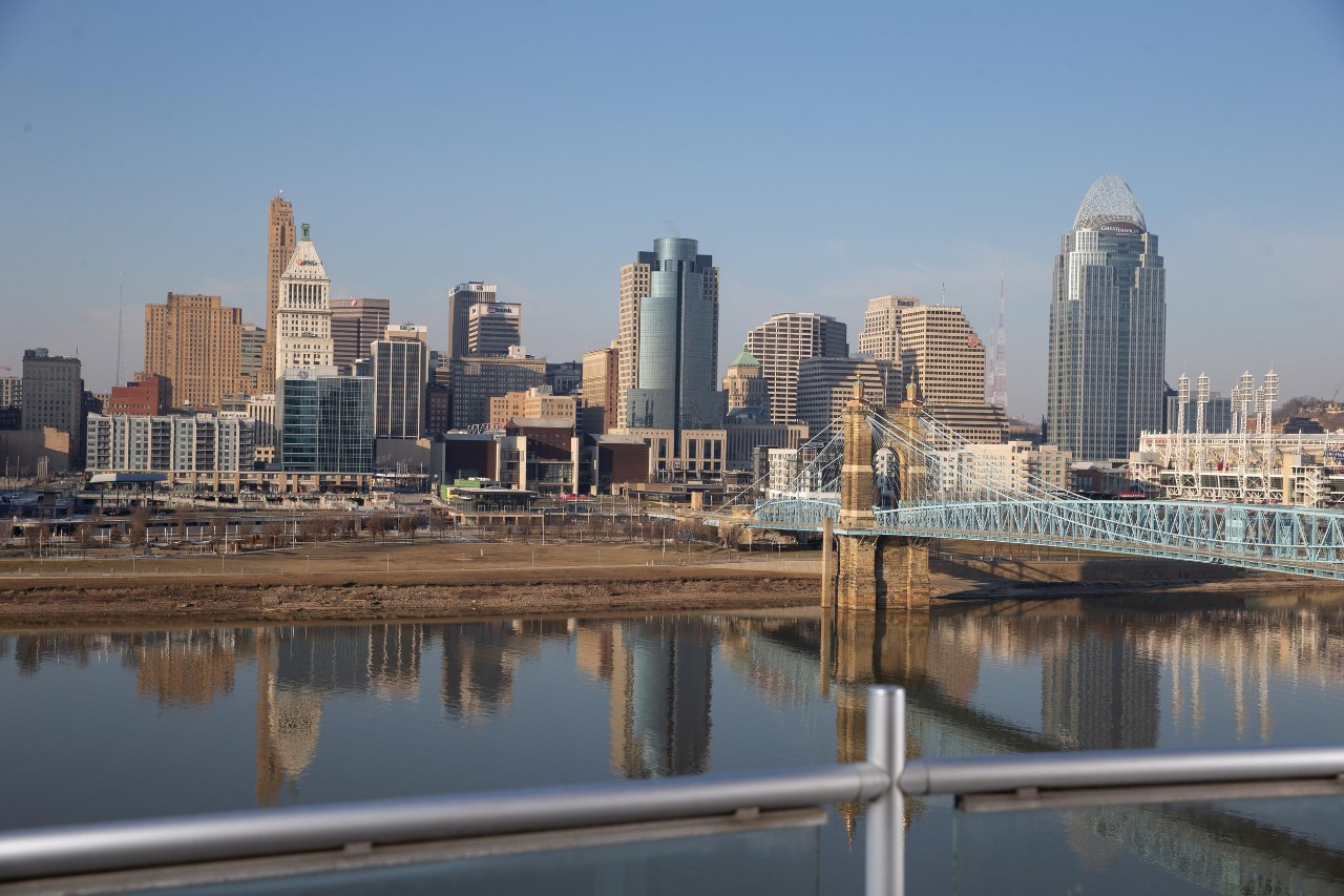 The Cincinnati skyline is reflected in the Ohio River.