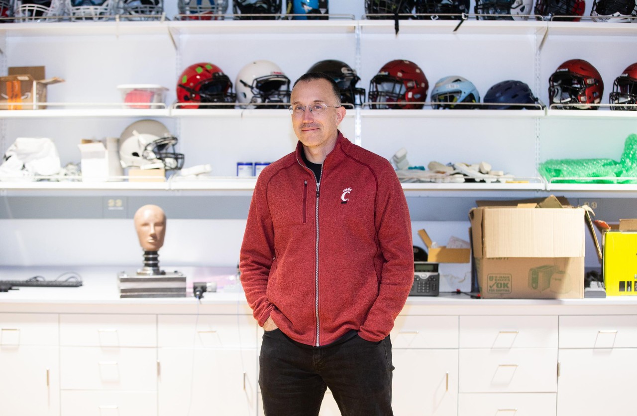 Eric Nauman stands in front of shelves full of sports equipment.