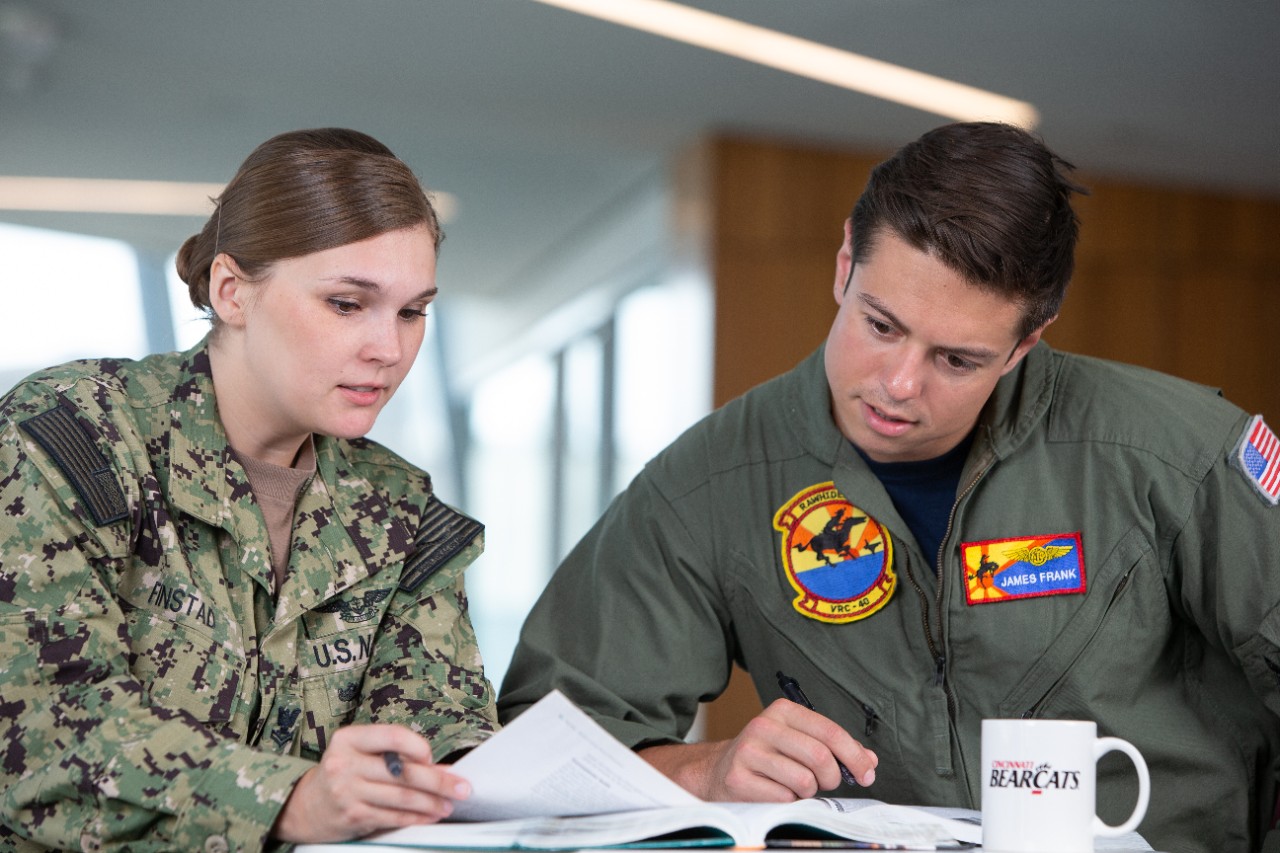 Photo of two military students in a discussion. Both are in casual uniforms.
