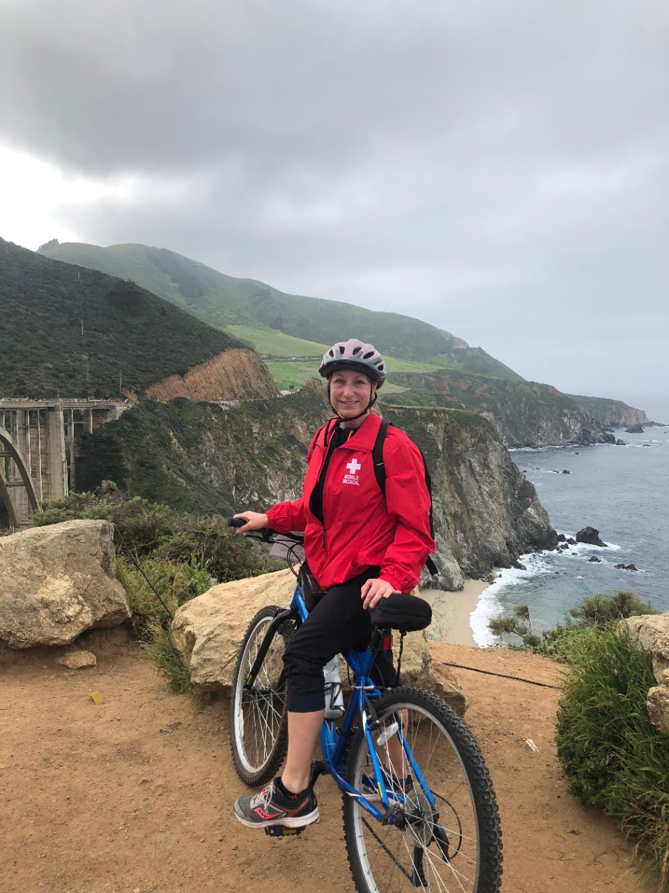 University of Cincinnati College of Nursing alumna Kimberly Godsey on a bicycle at the Big Sur Marathon