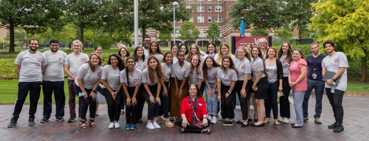Cancer Research Scholars students and Melinda Butsch Kovacic smile for a picture outside on UC's campus