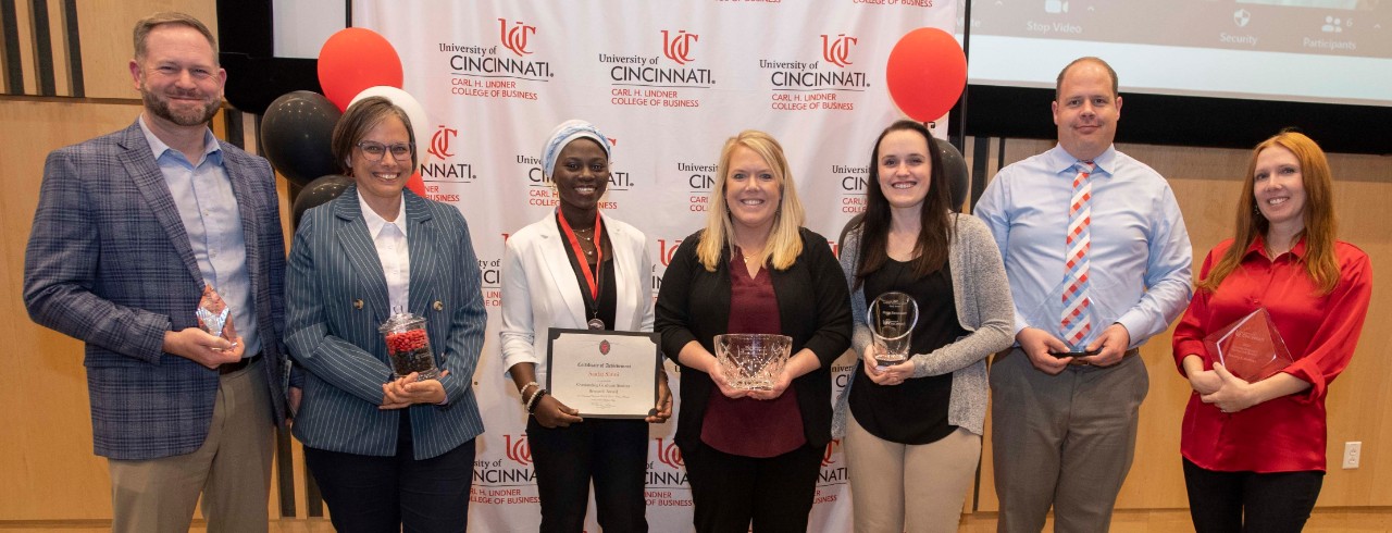 Lindner staff and faculty hold their awards after an awards reception.