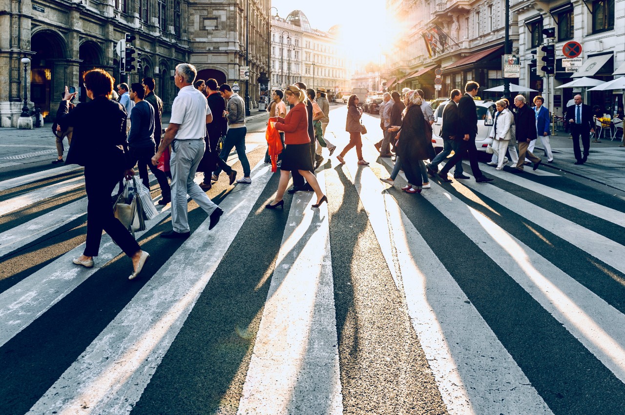 People walking across an urban street.