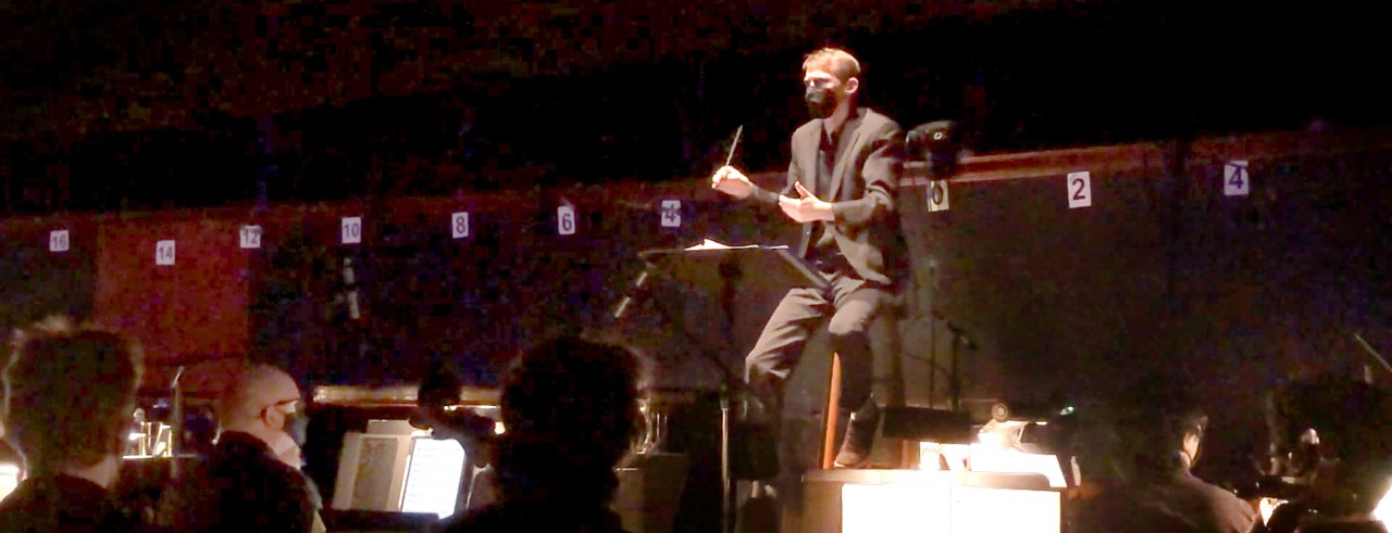 Faculty member Ian Axness conducts CCM students in the orchestra pit of Corbett Auditorium during a March 2022 performance of 'Pippin.' Photo/Provided