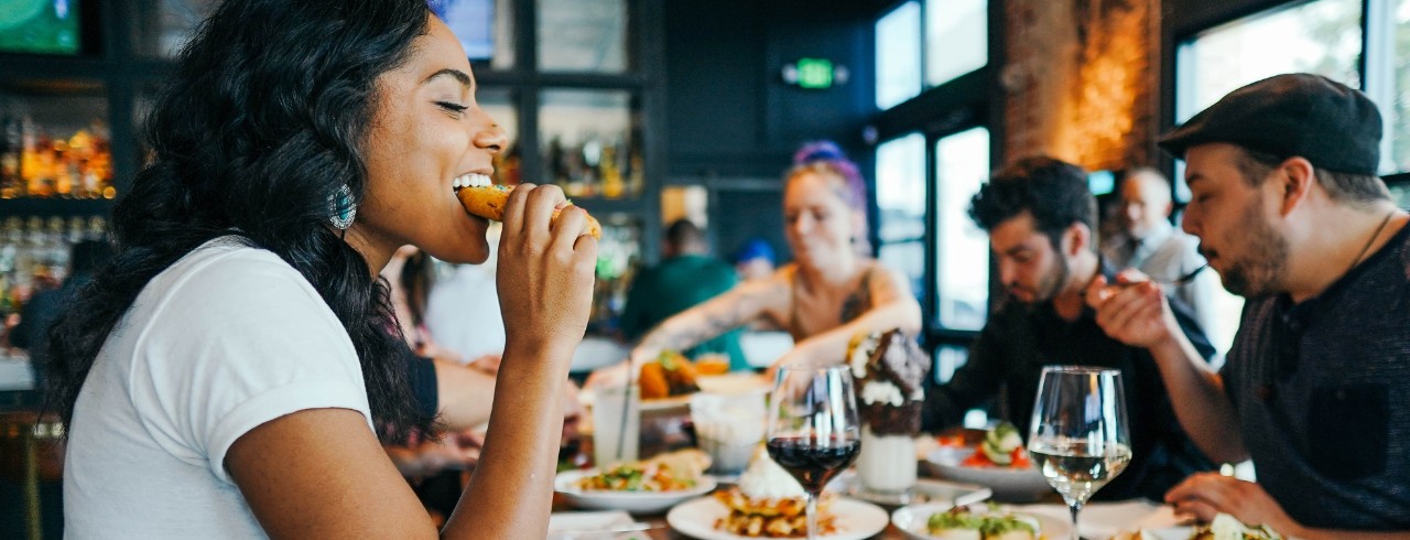 People eat together at a restaurant.