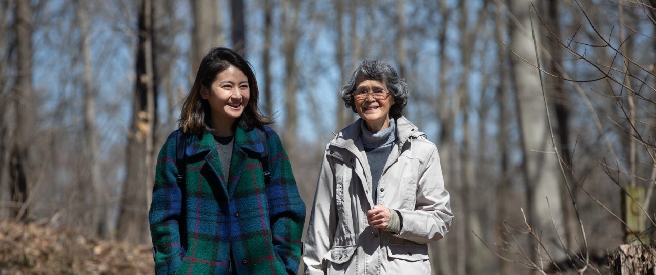 UC student Ruijia Hu, left, and Professor Susanna Tong look for woodpeckers in Burnet Woods.