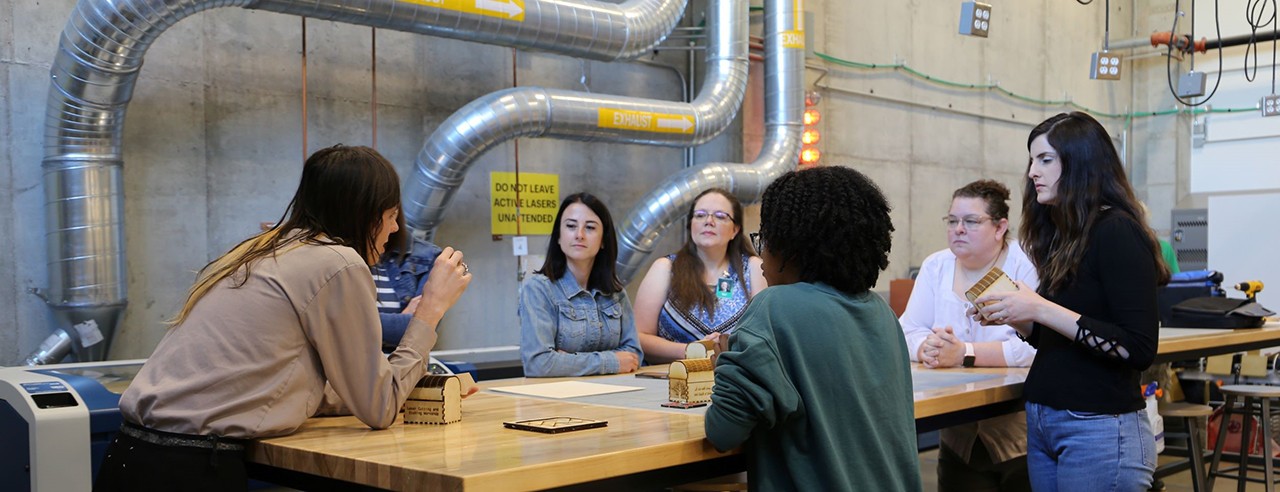 People working around a table in the Makerspace.