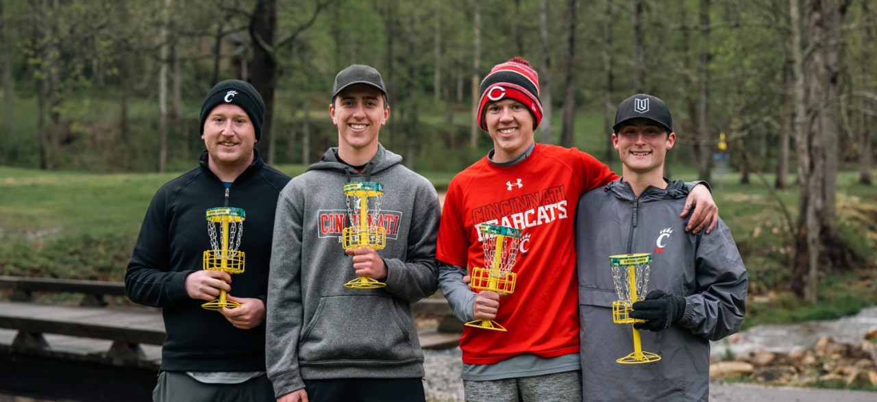 UC's four-member national champion Discats teammates hold their trophies.