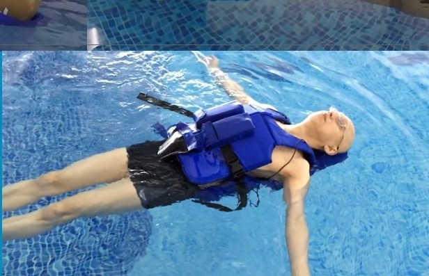 A patient demonstrates an adaptive hydrotherapy wetsuit.