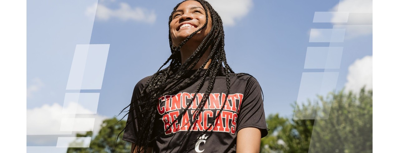 woman smiling wearing a University of Cincinnati shirt