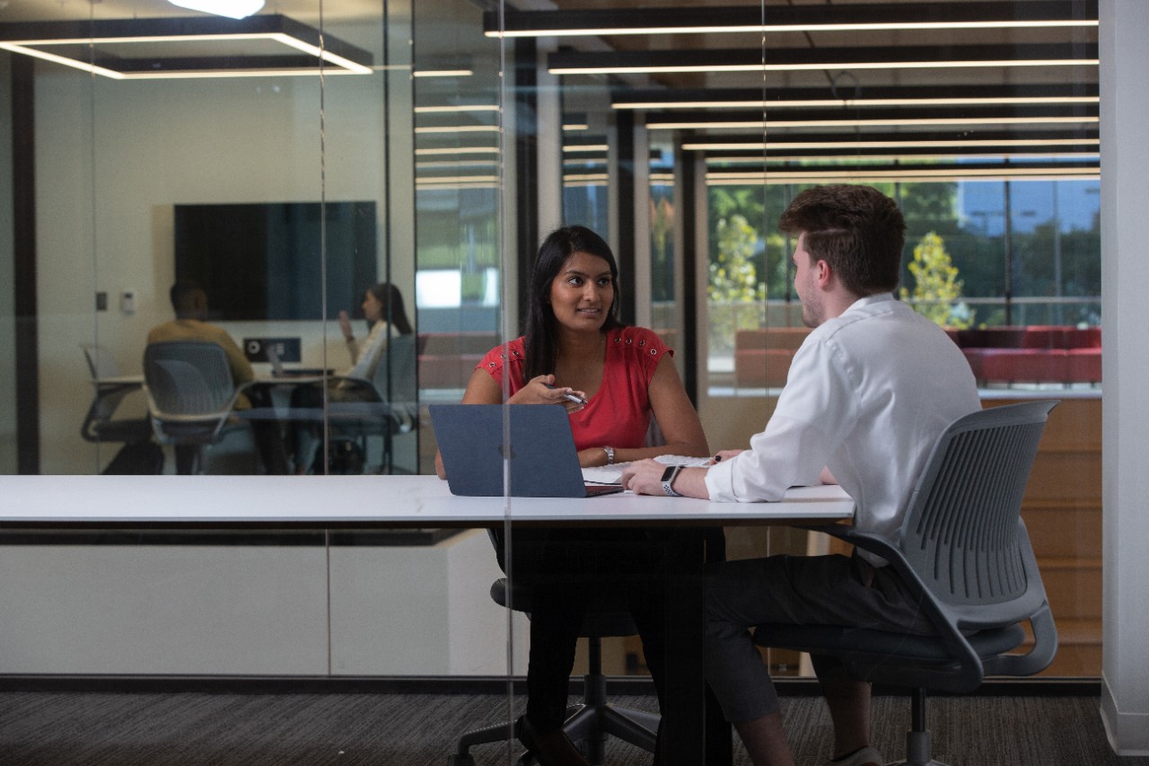 two people sitting at a desk