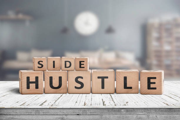 Side hustle sign on a plank table in a decorative room with a clock