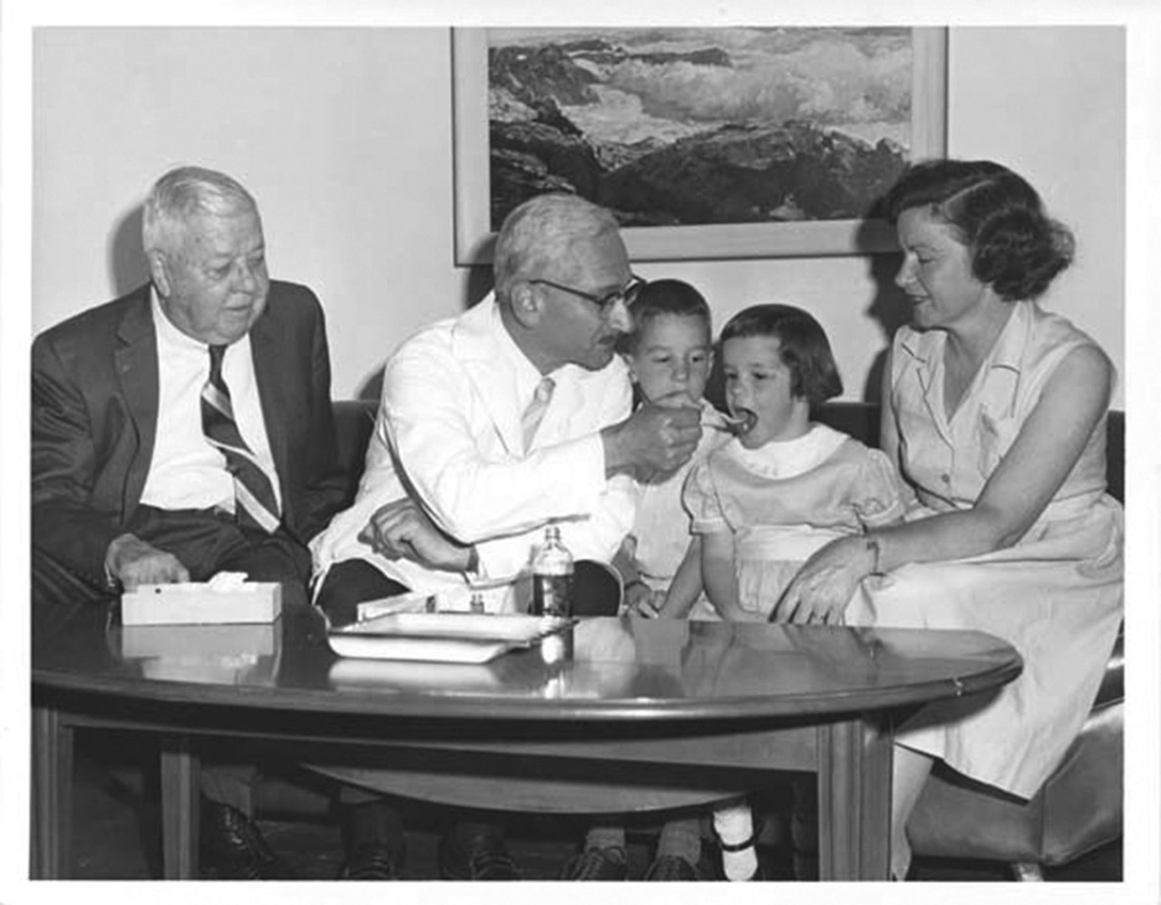 Albert Sabin administers oral polio vaccine to children.